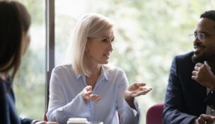 Woman addressing employees during business meeting